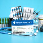 Health insurance card policy with meds and medical equipment on blue background.